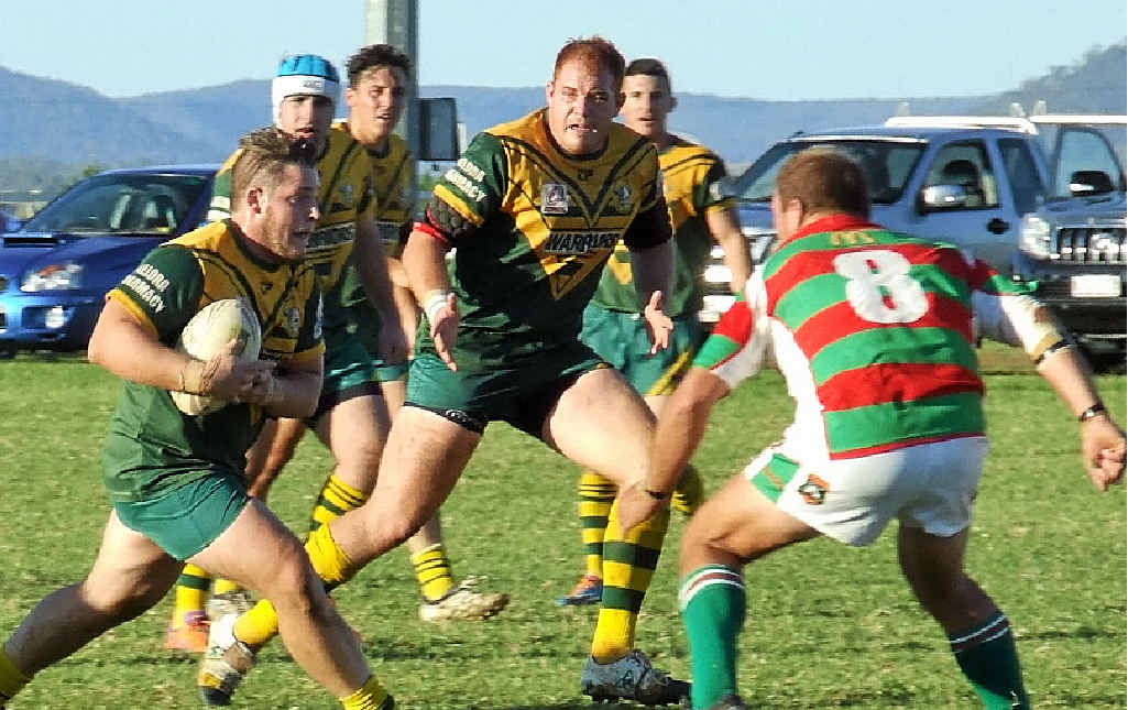 Wattles bookends Mitch Hannant, with the ball, and Michael Bermingham on a charge upfield against the Pittsworth Danes at Platz Oval on Sunday. Wattles bookends Mitch Hannant, with the ball, and Michael Bermingham on a charge upfield against the Pittsworth Danes at Platz Oval on Sunday.